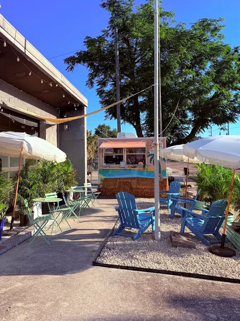 The BrewKini’s trailer and patio at Shuffle, with umbrellas and Adirondack chairs